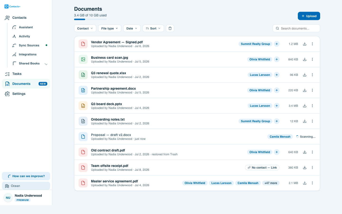 The ContactsPlus Documents library listing files attached to contacts — a signed vendor agreement, a business card scan, a renewal quote and a board deck, each with the contacts it is linked to, its size and a download button.